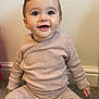 baby, child, smiling, sitting, carpet, clothing, socks, indoor, face, person, long_sleeve, pants, cute, young, happy, infant, wall, floor, portrait, casual