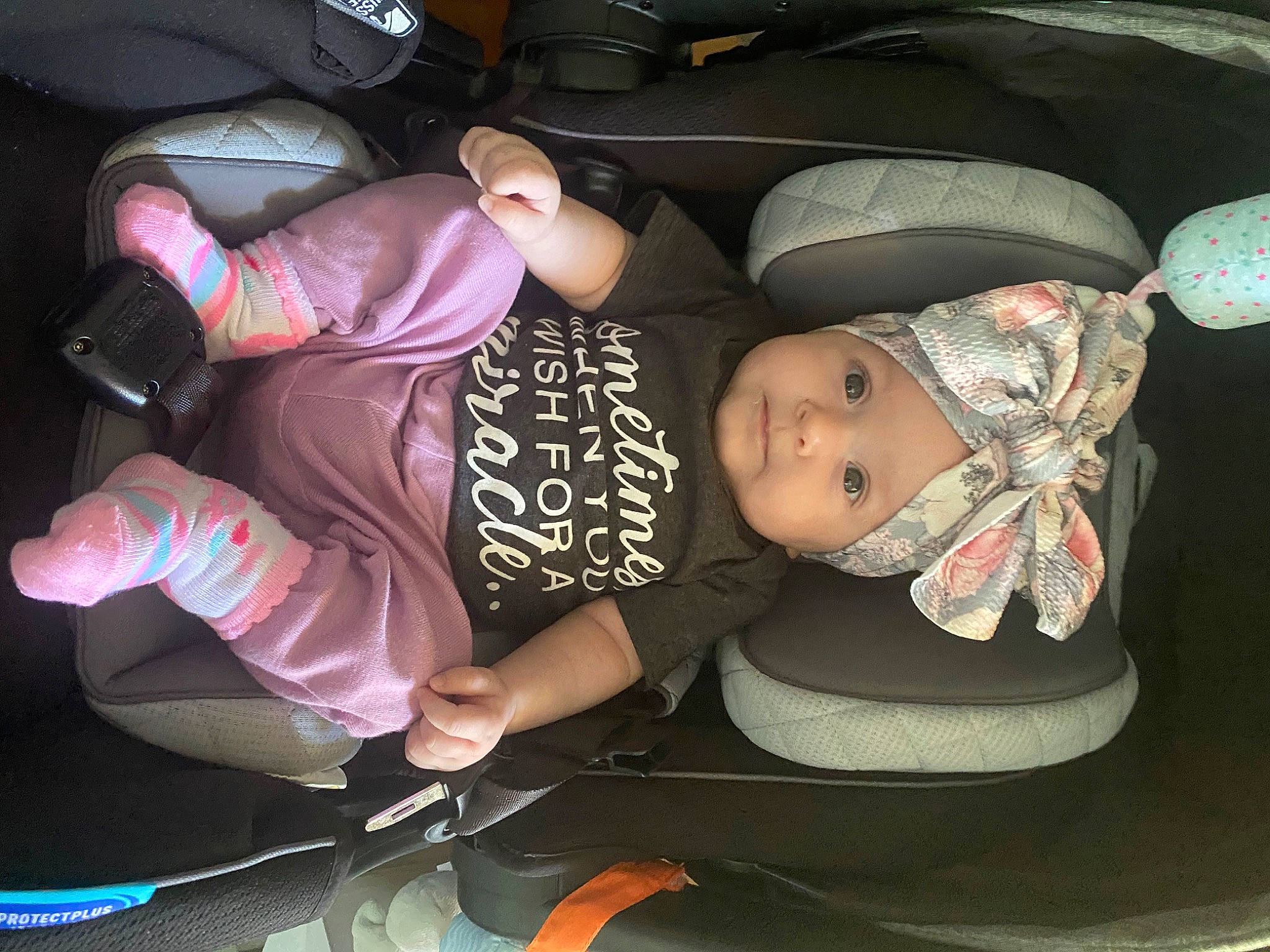 Michaela is registered to the contest to win money with this photo: auto_part, baby, baby_carriage, baby_products, baby_toddler_clothing, car_seat, carmine, child, comfort, finger, fun, hat, headwear, helmet, lap, mouth, person, sitting, thigh, toddler