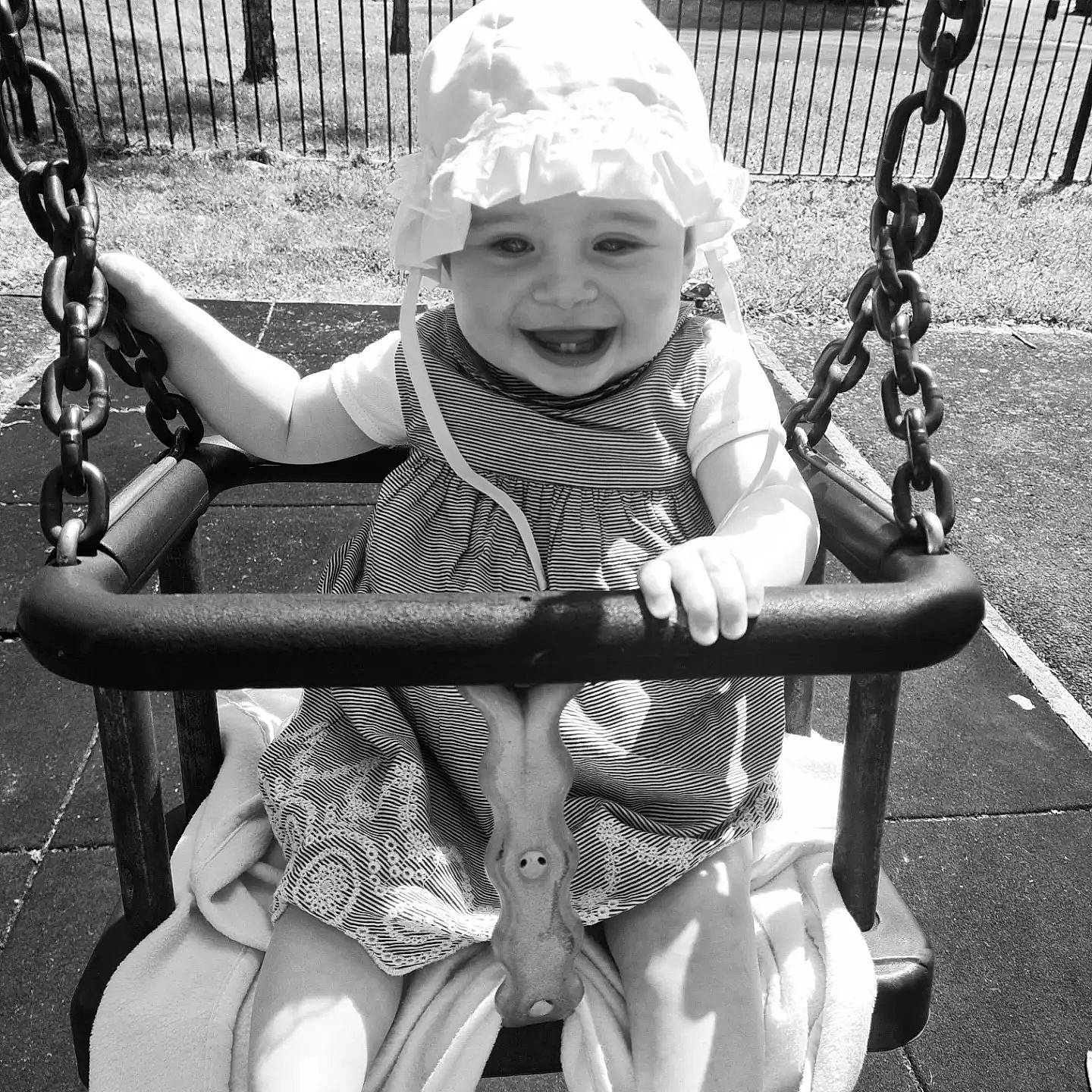 Esmae is registered to the contest to win money with this photo: arm, baby, black_and_white, cool, facial_expression, fun, hand, happy, headwear, human_body, joy, leisure, outdoor_play_equipment, people, person, photograph, recreation, skin, smile, style