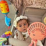Belle joined the competition — help win amazing prizes! baby, child, closeup, colorful, comfort, cute, expression, fabric, face, fan, hand, headband, infant, outdoor, person, portrait, seatbelt, soft_toy, stroller, toy