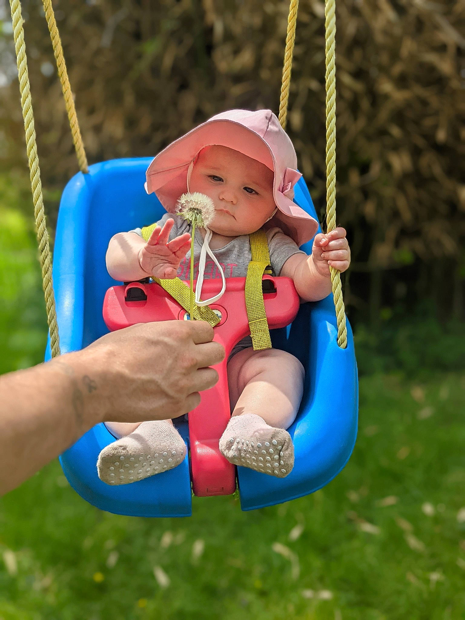 Coraline is registered to the contest to win money with this photo: baby, baby_toddler_clothing, child, city, electric_blue, fun, grass, hand, happy, headwear, leisure, outdoor_play_equipment, people_in_nature, person, play, playground, recreation, rope, swing, thumb