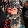 Steven Olivier is registered to the contest to win money with this photo: baby, child, face, fur_hat, fur_scarf, plaid_shirt, red_clothing, blue_clothing, indoor, person, portrait, cute, warm_clothing, winter, hat, scarf, eyes, expression, human, young