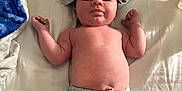Steven Olivier is registered to the contest to win money with this photo: baby, infant, shirt, hat, pants, bed, blanket, bedding, clothing, lying_down, cute, child, person, skin, indoors, newborn, soft, casual, relaxed, sleepwear