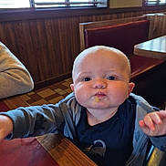 Max joined the competition — help win amazing prizes! baby, child, face, food, table, diner, booth, window, curious, expression, clothing, jacket, indoor, person, seat, wood_paneling, light, mouth, hand, cute