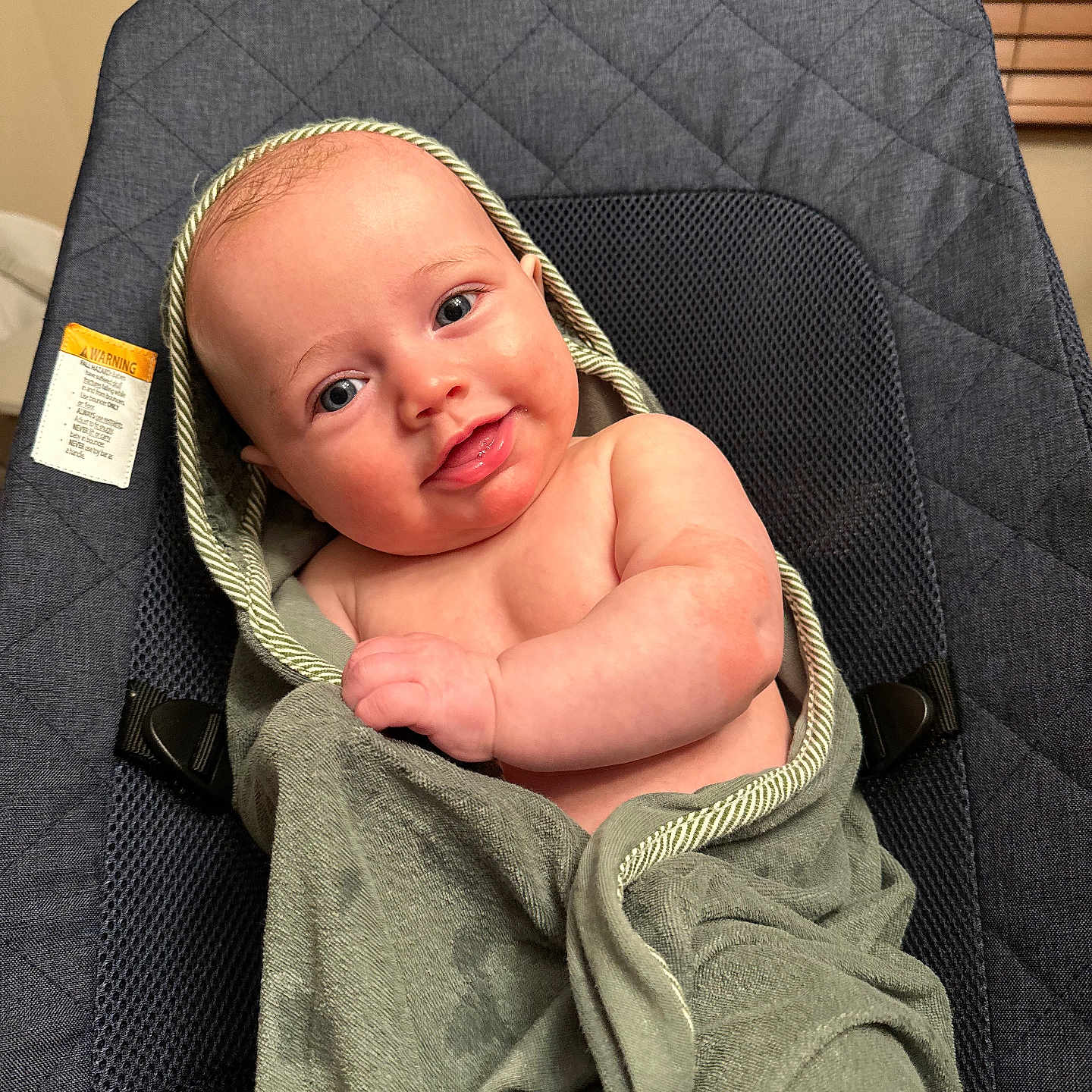 Leo is registered to the contest to win money with this photo: baby, blanket, chair, clothing, cushion, face, furniture, happy, hat, head, homedecor, hood, knitwear, newborn, person, photography, portrait, smile, sweater, towel