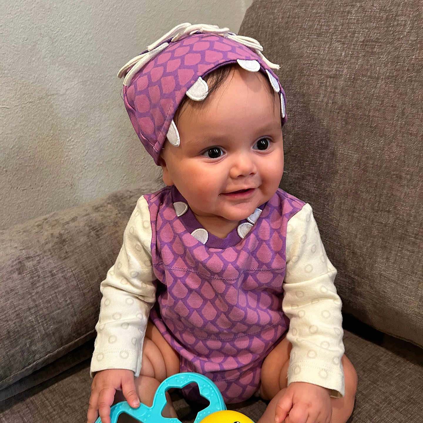 Thairy is registered to the contest to win money with this photo: architecture, baby, bonnet, building, cap, clothing, couch, cushion, face, furniture, hat, head, homedecor, indoors, livingroom, person, photography, portrait, sitting, toy