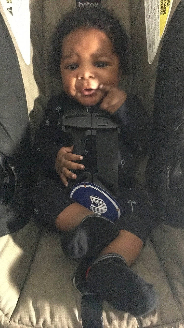 Arion is registered to the contest to win money with this photo: auto_part, baby, baby_carriage, car_seat, cheek, child, comfort, cool, eye, flash_photography, fun, happy, nail, person, personal_protective_equipment, sitting, skin, smile, t_shirt, thumb