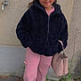 Julianna a rejoint le concours — aidez-le/la à gagner de superbes lots ! child, girl, smiling, braided_hair, black_jacket, pink_pants, handbag, standing, outdoor, concrete_wall, sidewalk, casual_clothing, footwear, person, urban, fashion, portrait, young, happy, street