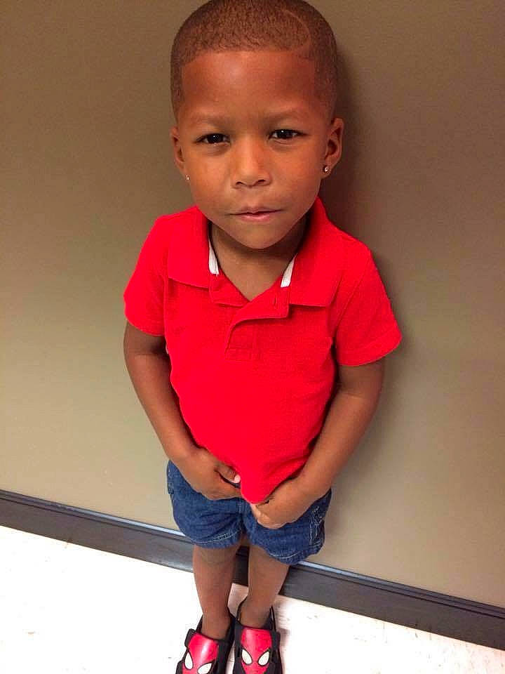 Kamron is registered to the contest to win money with this photo: arm, boy, cheek, child, child_model, chin, cool, girl, neck, outerwear, person, product, red, shoulder, sitting, skin, sleeve, smile, standing, t_shirt