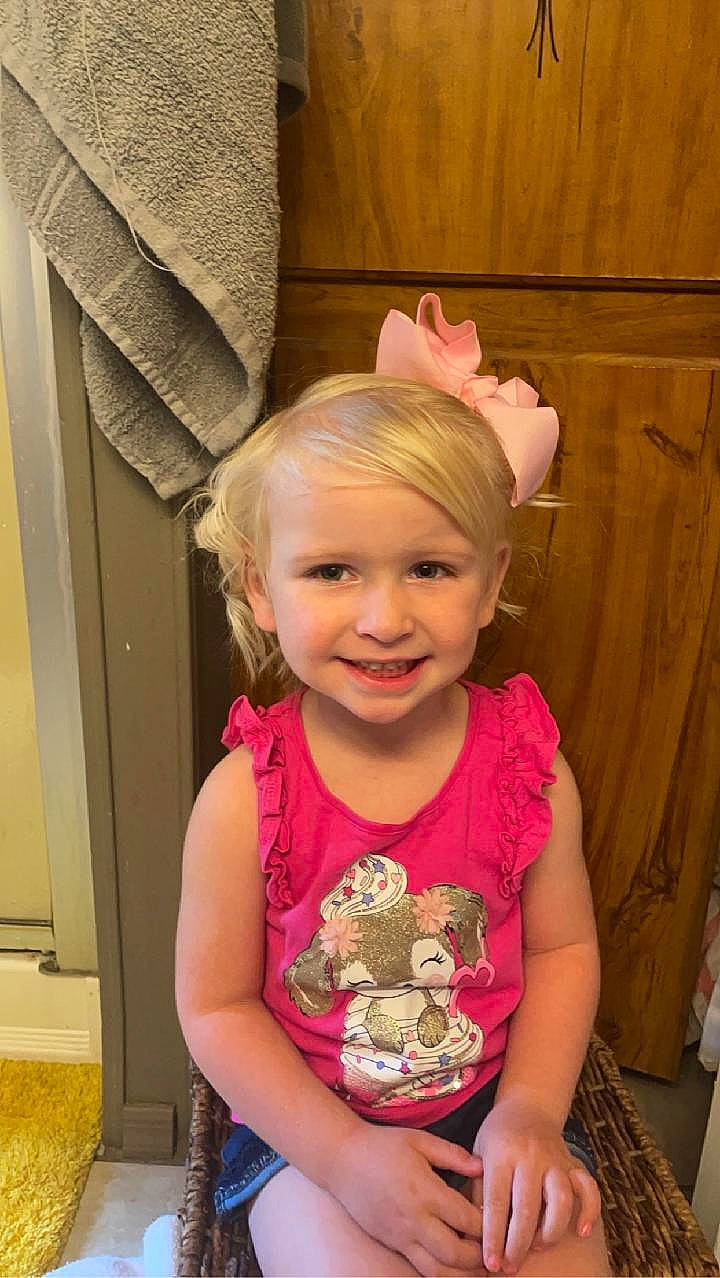 Hadleigh is registered to the contest to win money with this photo: baby_toddler_clothing, cheek, chin, eye, face, facial_expression, fun, hairstyle, happy, head, headgear, human_body, iris, joy, magenta, person, pink, purple, skin, sleeve