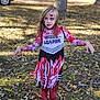 Nova is registered to the contest to win money with this photo: child, zombie, cheerleader, costume, face_paint, blood_splatter, autumn, leaves, outdoor, grass, tree, pose, scary, makeup, long_hair, red, white, black, legs, feet