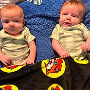 Holden Hudson joined the competition — help win amazing prizes! babies, baby_clothing, blue_blanket, cartoon_blanket, children, close_up, cozy, eyes, faces, family_photo, indoors, infants, lying_down, matching_outfits, onesies, plush_blanket, portrait, short_hair, sitting, twins
