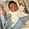 Messiah is registered to the contest to win money with this photo: newborn, baby, infant, sleeping, hospital, blanket, bassinet, white, wrapped, clothing, person, peaceful, cute, resting, skin, face, hand, healthcare, indoor, laying