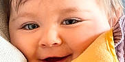 Amelie is registered to the contest to win money with this photo: baby, face, smile, blanket, cozy, child, close_up, happy, soft, warm, portrait, head, skin, hair, expression, infant, comfort, indoors, young, candid