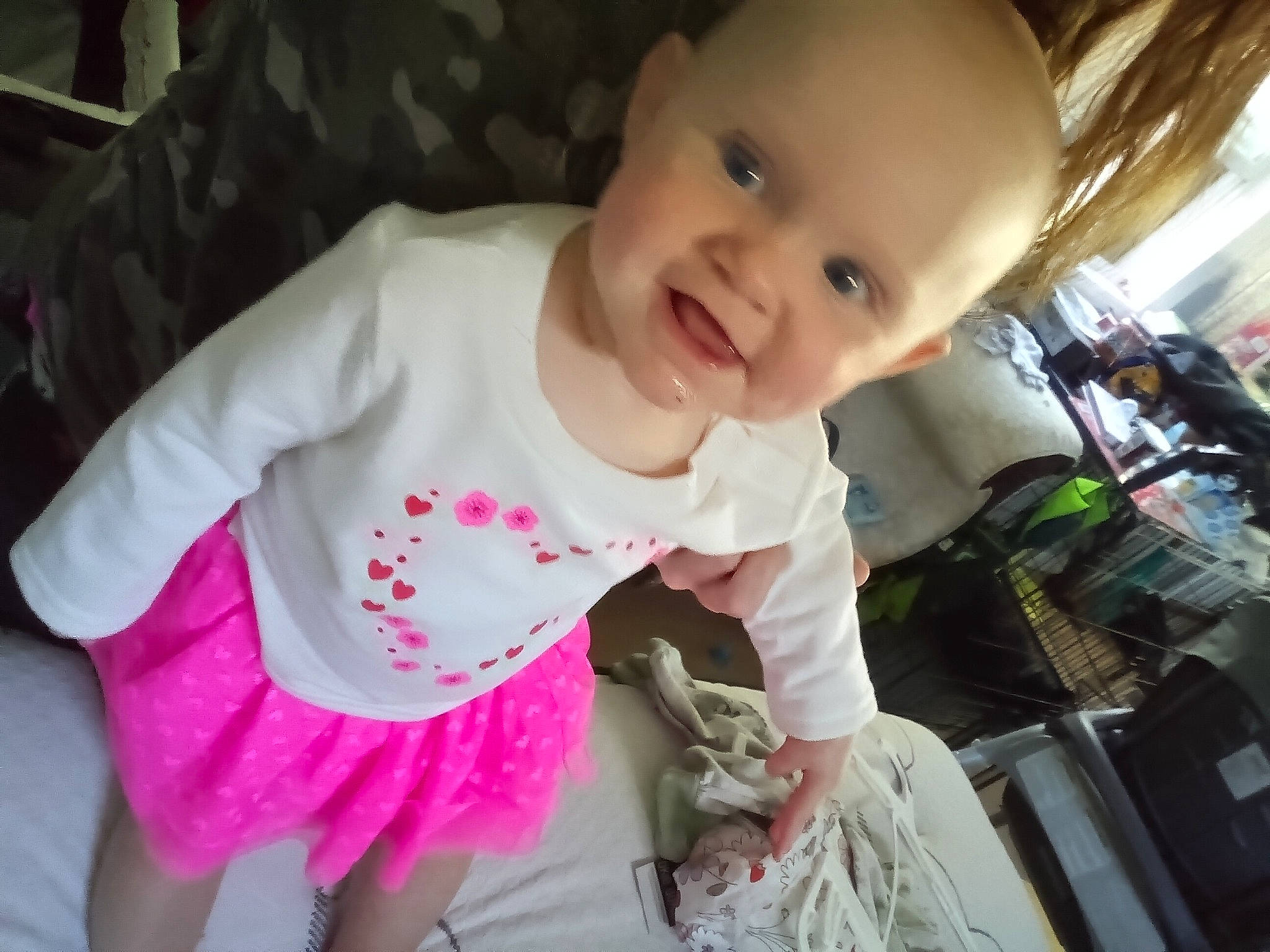 Luna is registered to the contest to win money with this photo: baby, baby_products, baby_toddler_clothing, cheek, child, eye, finger, fun, happy, iris, lip, mouth, nose, person, pink, product, skin, sleeve, smile, t_shirt