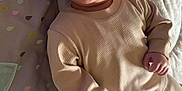 Myles is registered to the contest to win money with this photo: baby, infant, smiling, tongue_out, pajamas, blanket, baby_mat, floor, indoors, cute, child, person, happy, lying_down, soft_texture, clothing, head, face, hand, foot
