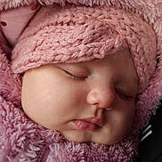 Giulia participe au concours pour gagner de l'argent avec cette photo : adorable, baby, child, closeup, cozy, cute, face, fluffy_clothing, headwear, infant, knit_hat, peaceful, pink, portrait, resting, sleeping, soft_texture, warm, winter_wear, young_child