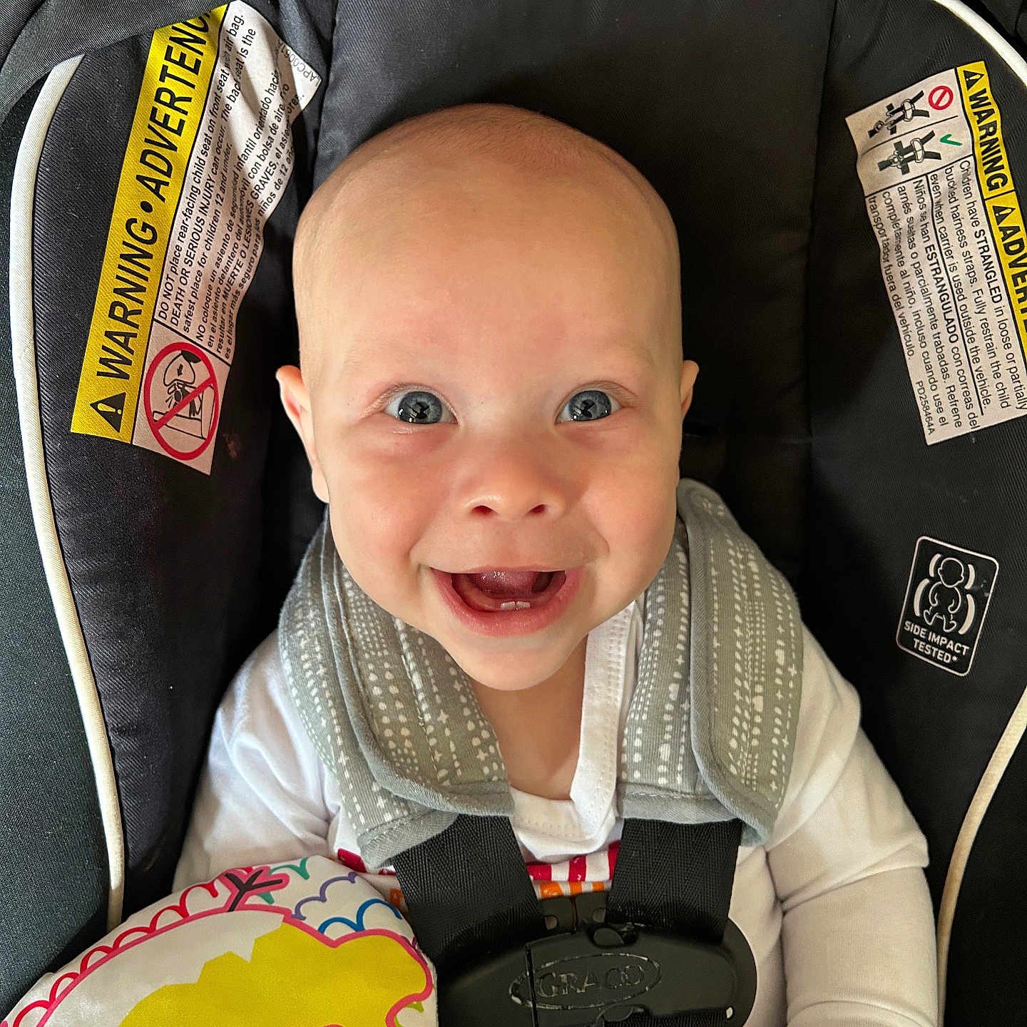Hudson is registered to the contest to win money with this photo: baby, babylaughing, car, car_interior, carseat, clothing, coat, cushion, face, happy, head, homedecor, laughing, person, photography, portrait, smile, stroller, transportation, vehicle