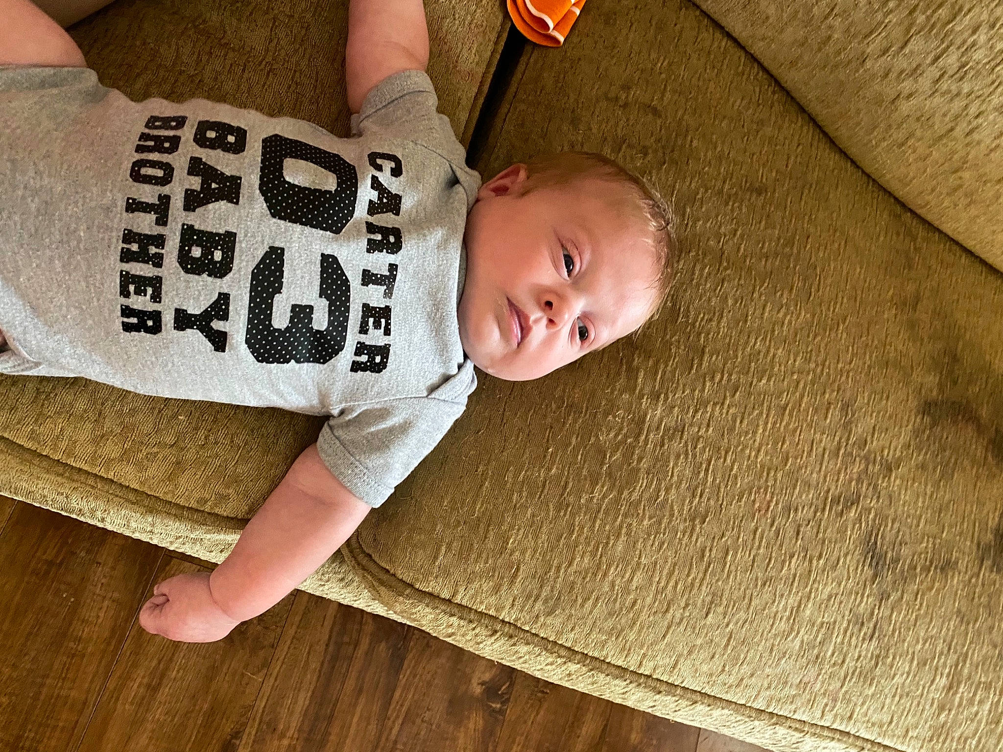 Carter joined the competition — help win amazing prizes! baby, baby_toddler_clothing, comfort, elbow, face, flash_photography, floor, flooring, hardwood, human_leg, knee, long_sleeved_t_shirt, pattern, person, sleeve, t_shirt, thigh, toddler, vertebrate, wood