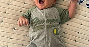 Luka joined the competition — help win amazing prizes! baby, infant, smile, happy, onesie, clothing, blanket, pattern, blue, green, face, hand, foot, lying_down, cute, child, person, indoors, portrait, playful