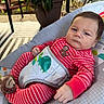 Luka is registered to the contest to win money with this photo: baby, infant, striped_pajamas, red_clothing, monkey_slippers, diaper_cover, turtle_design, baby_seat, outdoor, potted_plant, patio_furniture, face, person, cushion, relaxing, portrait, young_child, daylight, expression, home