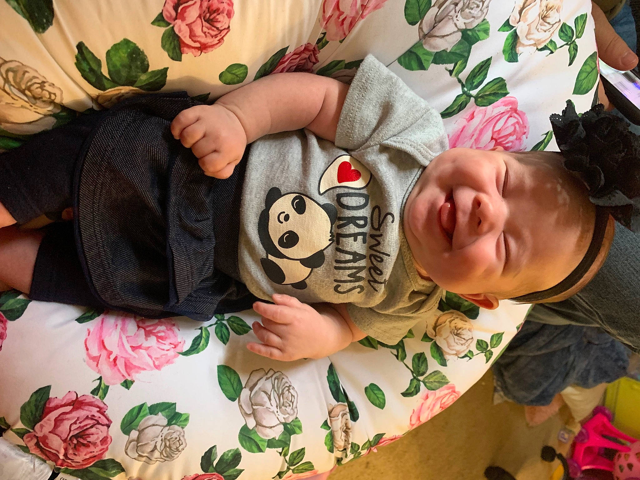 Brookelynn is registered to the contest to win money with this photo: baby_toddler_clothing, child, comfort, finger, grass, green, hand, happy, human_leg, linens, pattern, person, room, skin, sleeve, smile, textile, thigh, toddler, wood