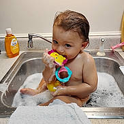 Jasiah joined the competition — help win amazing prizes! baby, child, toddler, bath, bathtub, sink, bubbles, bubble_bath, bath_toy, toy, shampoo, towel, kitchen, faucet, wet_hair, sitting, 裸?, smiling, indoor, portrait