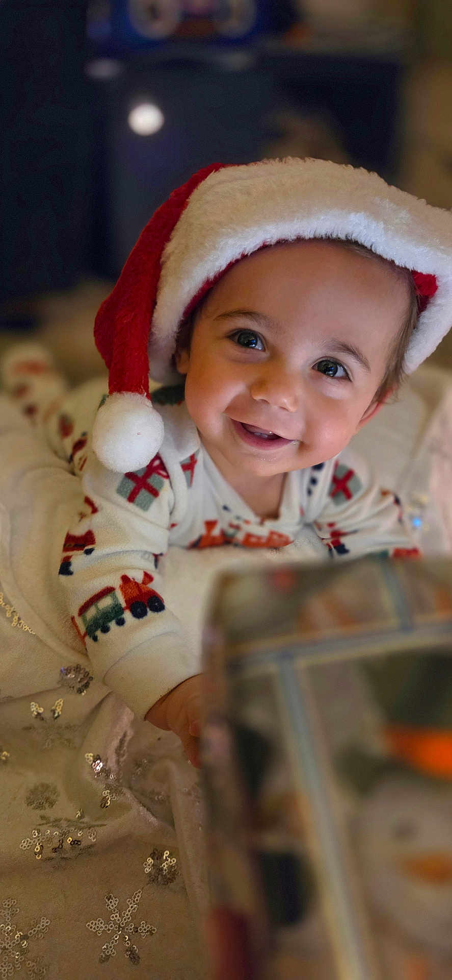 Ashton joined the competition — help win amazing prizes! baby, child, santa_hat, smile, holiday, christmas, pajamas, blanket, sparkles, snowflake, face, happy, indoor, cute, festive, infant, toy, present, warm, celebration