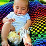 baby, cake, frosting, smiling, colorful_blanket, outdoor, grass, child, messy, happy, feet, legs, white_shirt, food, celebration, nature, cute, playful, portrait, sitting