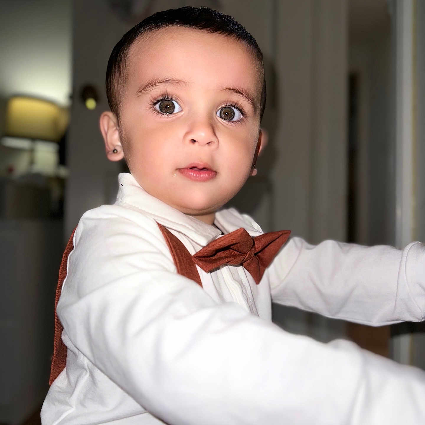 Keshav joined the competition — help win amazing prizes! baby, background_blur, bow_tie, brown_clothing, child, clothing, curious, cute, expression, eyes, face, hand, indoor, person, portrait, soft_lighting, suspenders, toddler, white_shirt, young_child