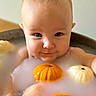 Asher is registered to the contest to win money with this photo: baby, bath_time, bathtub, child, cozy, cute, eyes, face, hands, infant, milk, milk_bath, orange_pumpkin, portrait, pumpkin, skin, smiling, tub, water, white_pumpkin