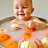 baby, chubby_cheeks, cute, feet, floating_objects, gourd, hands, happy, holiday_theme, infant, milkbath, orange, playful, portrait, pumpkin, skin, smile, tub, water, white