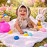 baby, balloons, basket, blanket, bonnet, bunny, child, cute, easter_eggs, festive, flowers, grass, happy, holiday, outdoor, plush_toy, portrait, sitting, smiling, spring