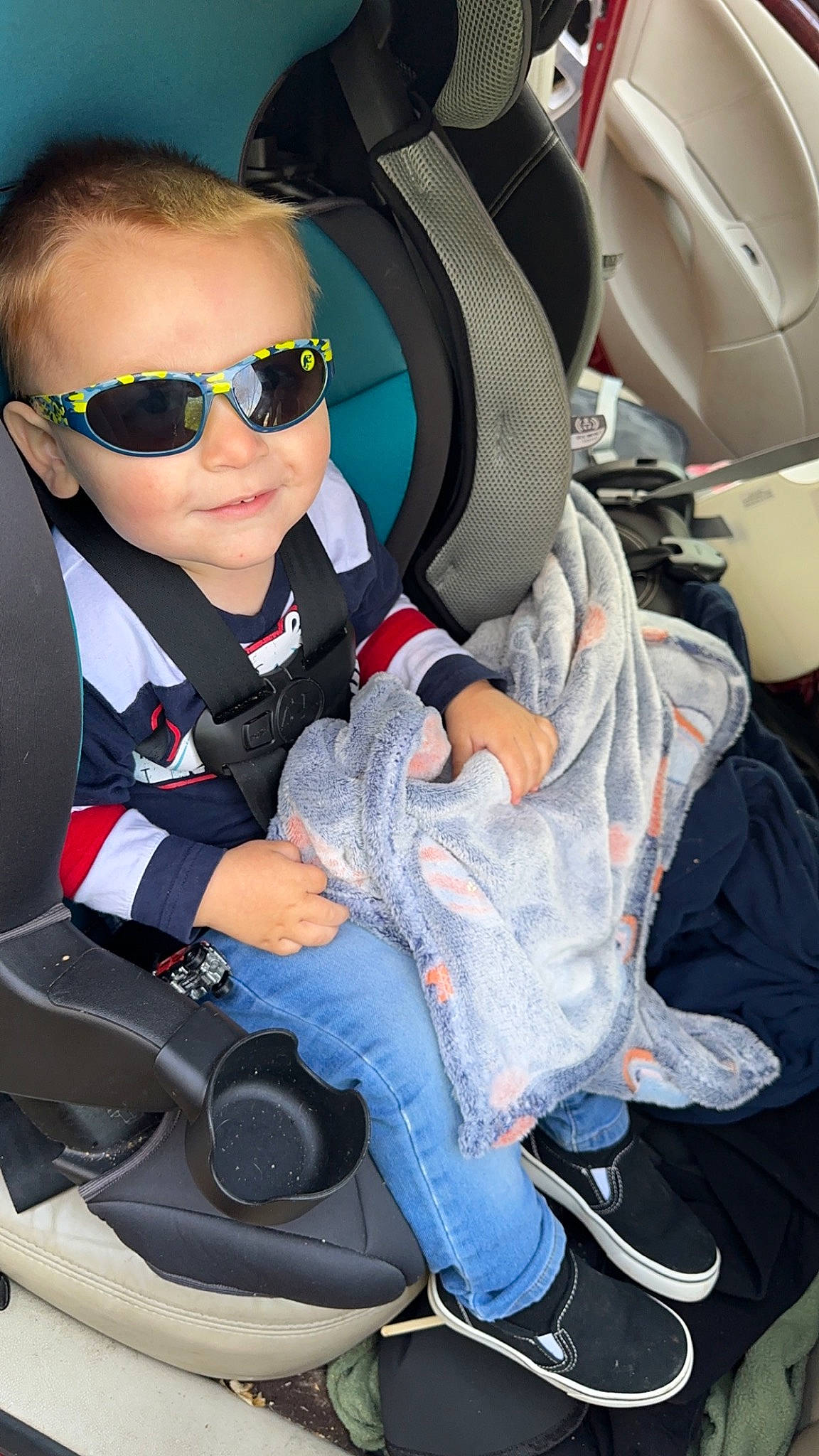 Waylon joined the competition — help win amazing prizes! auto_part, automotive_design, baby_carriage, car_seat, car_seat_cover, child, comfort, electric_blue, eyewear, goggles, lap, person, personal_protective_equipment, shoe, sitting, smile, sneakers, sunglasses, toddler, vehicle_door