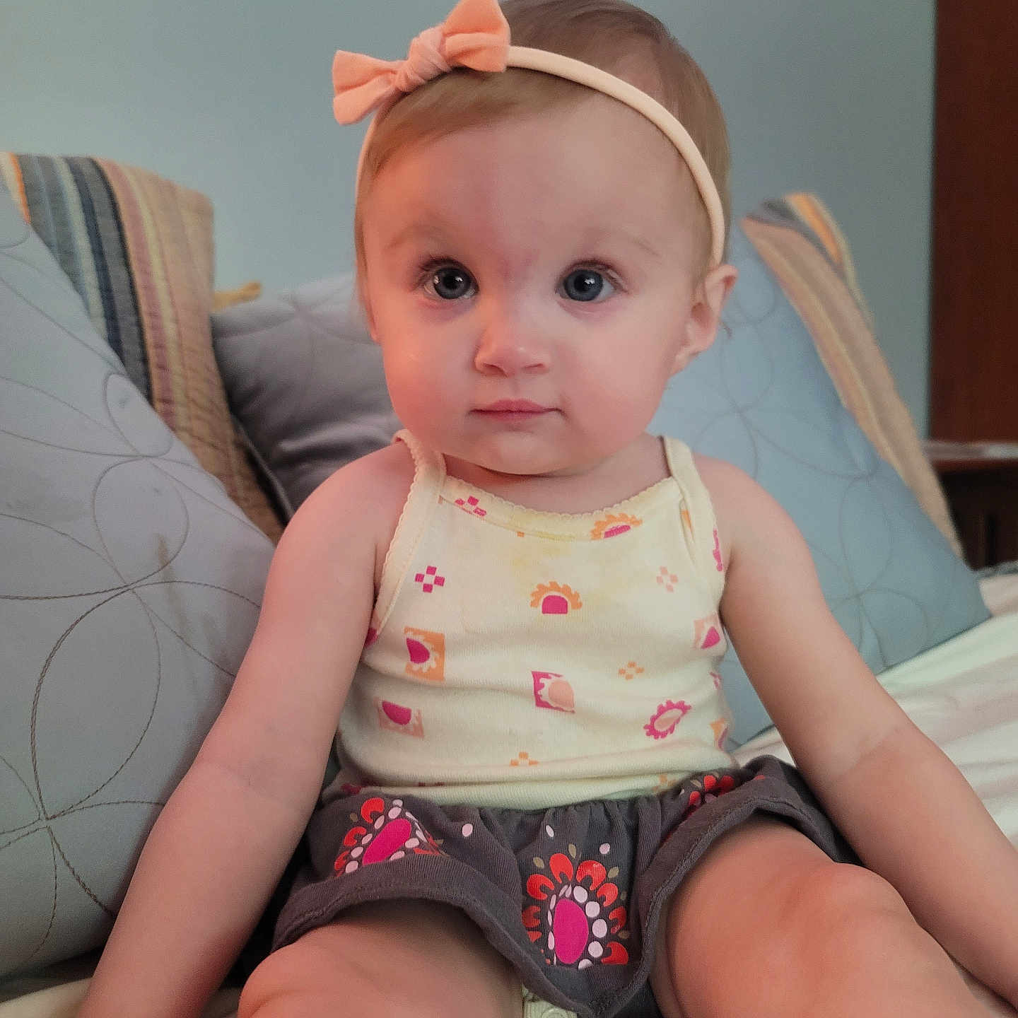 Spencer is registered to the contest to win money with this photo: accessories, architecture, baby, bodypart, building, clothing, couch, cushion, face, finger, furniture, hand, head, headband, homedecor, person, photography, portrait, shorts, sitting