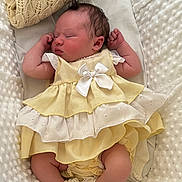 Maybelle joined the competition — help win amazing prizes! newborn, baby, sleeping, dress, yellow_dress, white_bow, blanket, soft_texture, infant, cute, cozy, resting, indoors, portrait, child, small_arms, peaceful, lace_socks, fabric, toddler