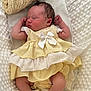 newborn, baby, sleeping, dress, yellow_dress, white_bow, blanket, soft_texture, infant, cute, cozy, resting, indoors, portrait, child, small_arms, peaceful, lace_socks, fabric, toddler