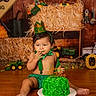 Zealand joined the competition — help win amazing prizes! baby, birthday, birthday_cake, cake, child, costume, farmer_theme, festive, food, green, hay_bales, indoor, portrait, sitting, smiling, toy_tractors, toddler, wooden_floor, party_hat, celebration