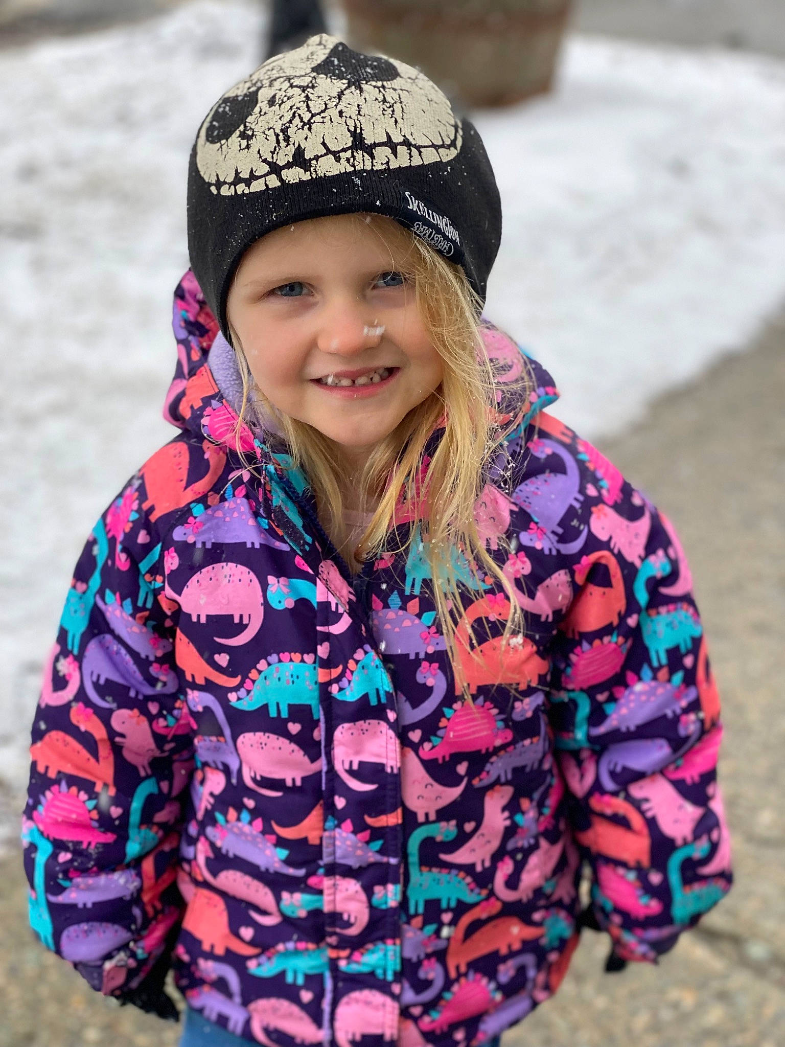 Ella is registered to the contest to win money with this photo: cap, cool, eye, face, freezing, fun, happy, head, headgear, headwear, human_body, jacket, joy, person, photograph, recreation, sleeve, smile, snow, street_fashion