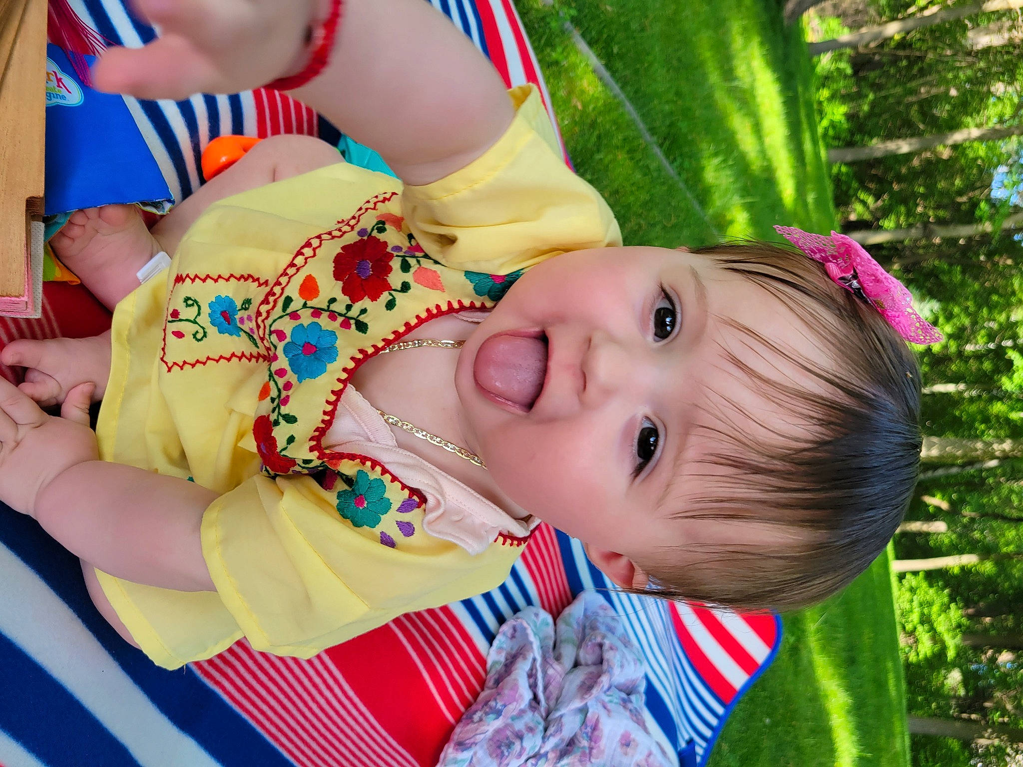 Maya is registered to the contest to win money with this photo: baby, baby_toddler_clothing, cheek, child, event, fun, grass, happy, leisure, people_in_nature, person, plant, recreation, smile, toddler, tree, vacation