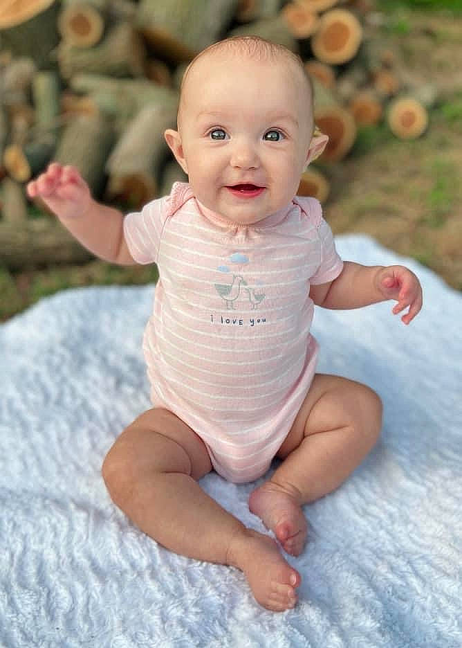 Lillian Rose is registered to the contest to win money with this photo: baby, baby_toddler_clothing, cheek, chin, dress, facial_expression, finger, flash_photography, grass, hairstyle, hand, happy, head, mammal, mouth, people_in_nature, person, skin, sleeve, smile