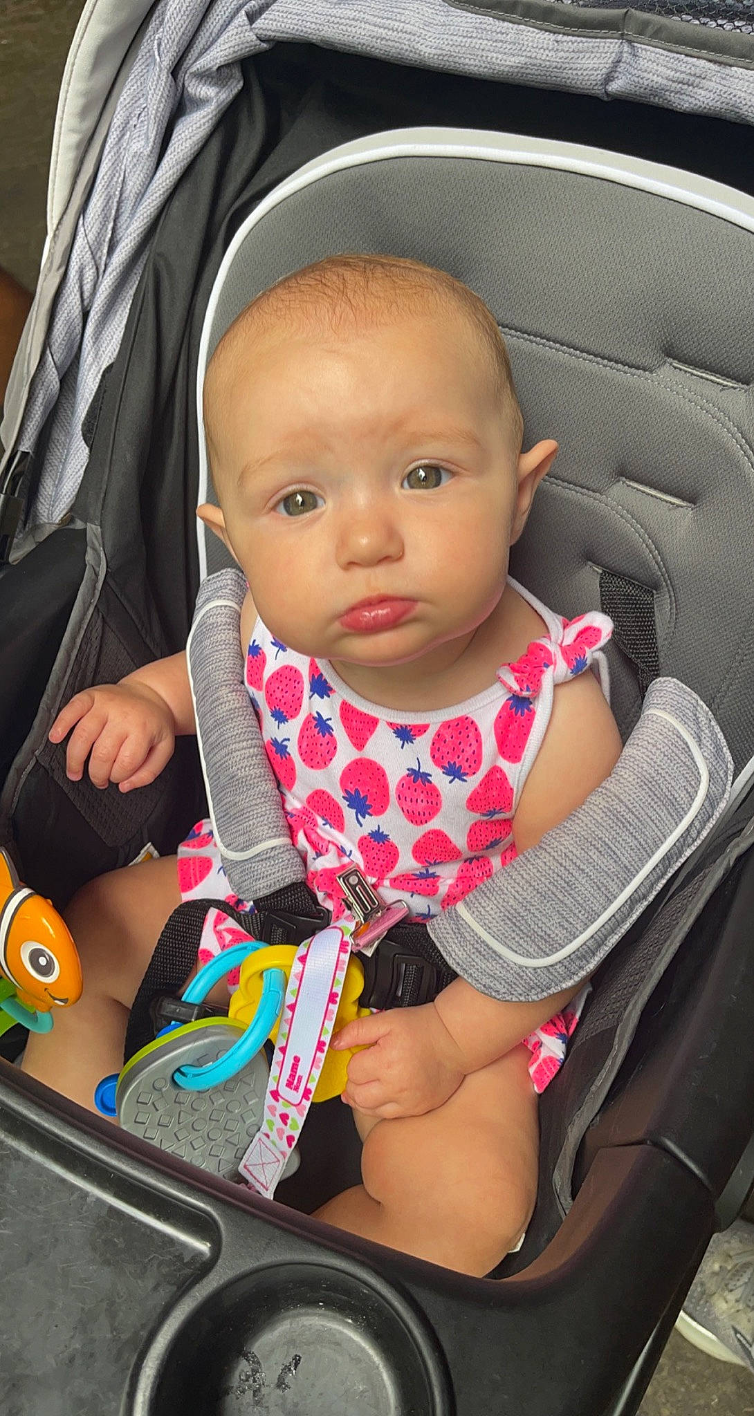 Lillian Rose is registered to the contest to win money with this photo: auto_part, baby, baby_carriage, baby_products, baby_safety, baby_toddler_clothing, car_seat, cheek, child, comfort, cool, facial_expression, fun, human, iris, person, product, seat_belt, sitting, skin