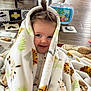 Myla is registered to the contest to win money with this photo: toddler, child, blanket, smile, hair, playmat, toy, floor, wooden_floor, animal_print, indoor, face, blue_eyes, cute, cozy, sitting, playtime, colorful, happy, young_child