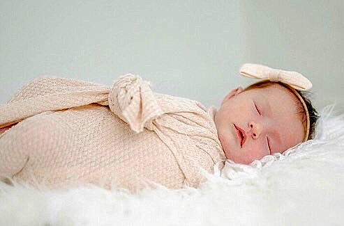 Amelia is registered to the contest to win money with this photo: arm, baby, baby_sleeping, baby_toddler_clothing, bedding, bedtime, child, comfort, fashion_accessory, foot, fur, headgear, human_body, linens, nap, peach, person, portrait_photography, sitting, skin