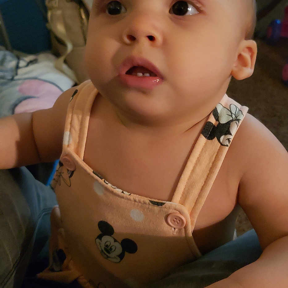 Kylie joined the competition — help win amazing prizes! baby, carpet, child, clothing, couch, curious, expression, face, furniture, hand, home, indoor, light, mickey_mouse, person, skin, sleeveless, toddler, toy, young_child