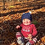 baby, cap, clothing, face, hat, head, land, leaf, nature, outdoors, pants, person, photography, plant, portrait, soil, tree, vegetation, wilderness, woodland