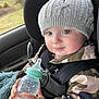 baby, beverage, bodypart, bonnet, bottle, cap, car, clothing, coat, face, finger, hand, hat, head, milk, person, photography, portrait, transportation, vehicle