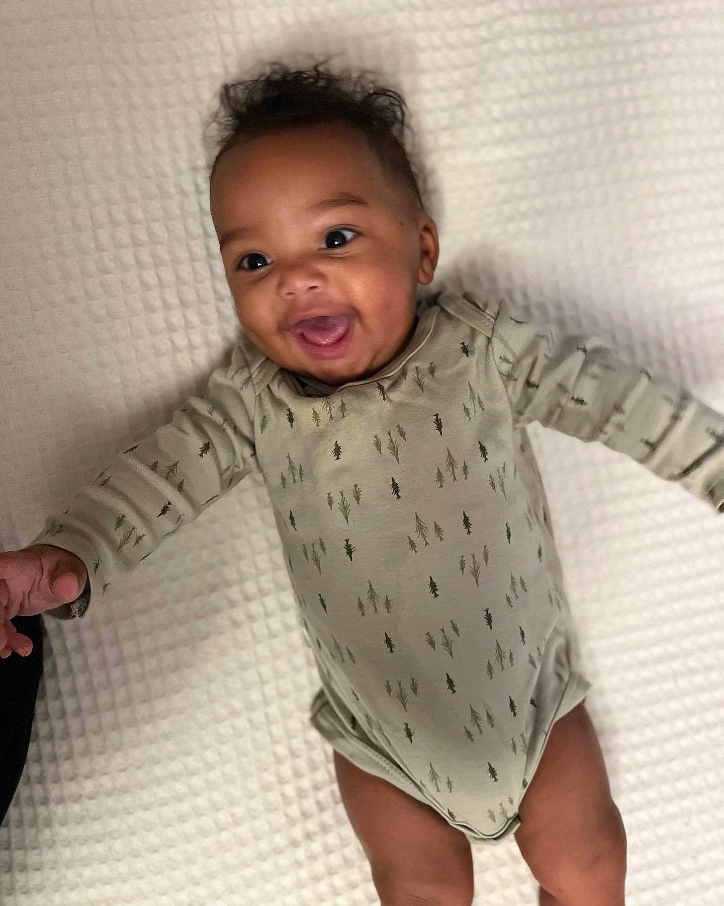 Damir is registered to the contest to win money with this photo: baby, baby_toddler_clothing, cheek, comfort, elbow, flooring, gesture, happy, head, knee, linens, neck, nose, outerwear, person, skin, sleeve, t_shirt, textile, thumb