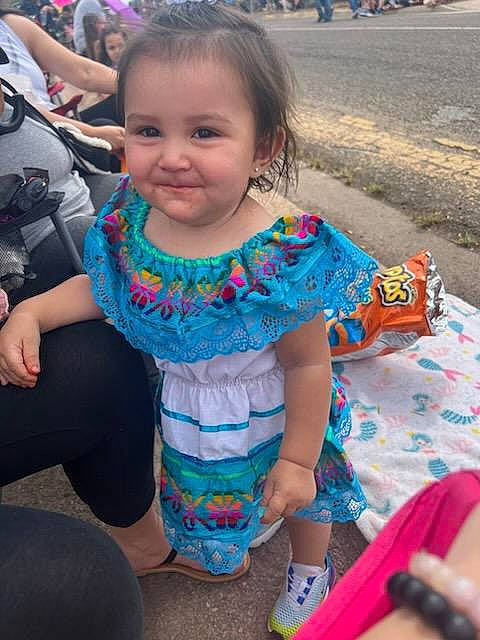 A'Mari is registered to the contest to win money with this photo: baby_toddler_clothing, blurred, child, event, eye, fun, hairstyle, happy, iris, joy, leisure, magenta, party, pattern, person, pink, recreation, sandal, sitting, skin