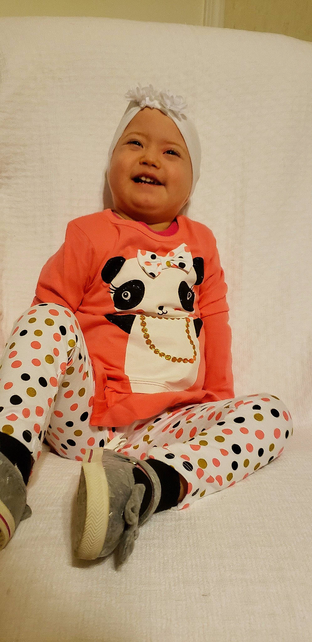 Sylvia is registered to the contest to win money with this photo: baby, baby_toddler_clothing, child, orange, pajamas, peach, person, pink, sleeve, smile, toddler